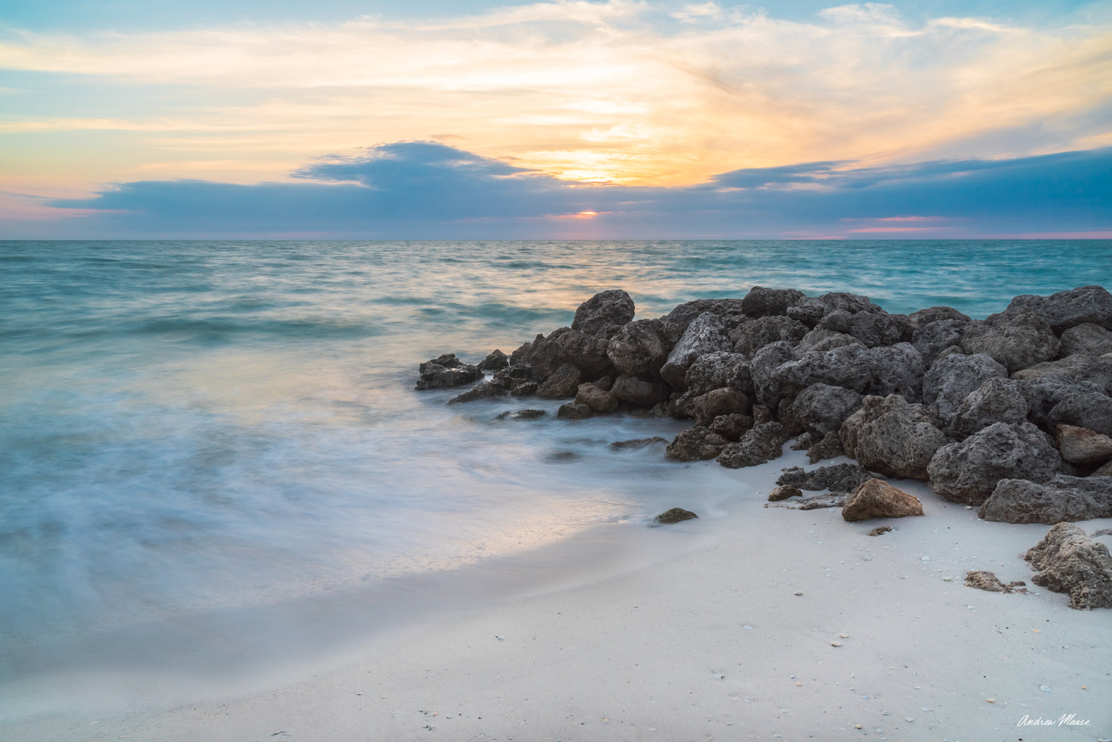 Fine art print of a cool colored sunset on Little Hickory Island in Bonita Springs, Florida next to the rocks – landscape photography by Andrew Mease