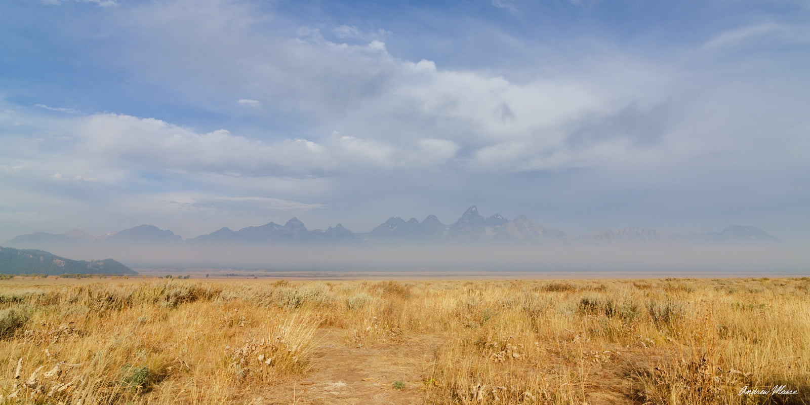 Fine art print panorama of a the Grand Teton Mountain range on a very hazy and cloudy morning in Grand Teton National Park and Wyoming – landscape photography by Andrew Mease