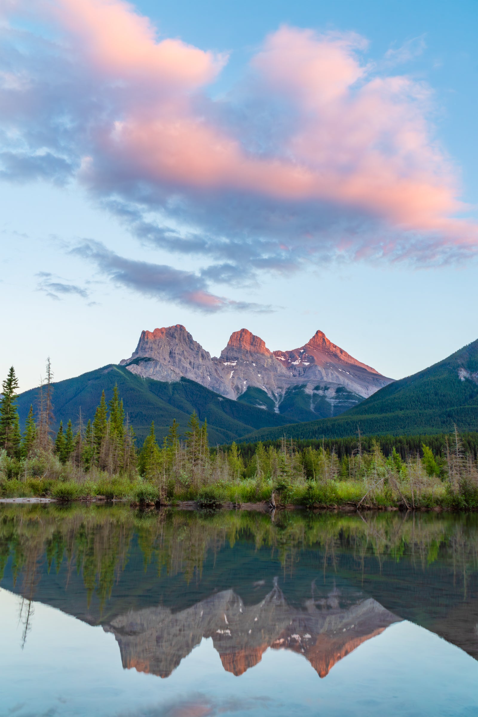 Fine art print of the three sisters mountain range near sunset with Fisherman's Creek in the foreground in Canmore, Alberta Canada – landscape photography by Andrew Mease